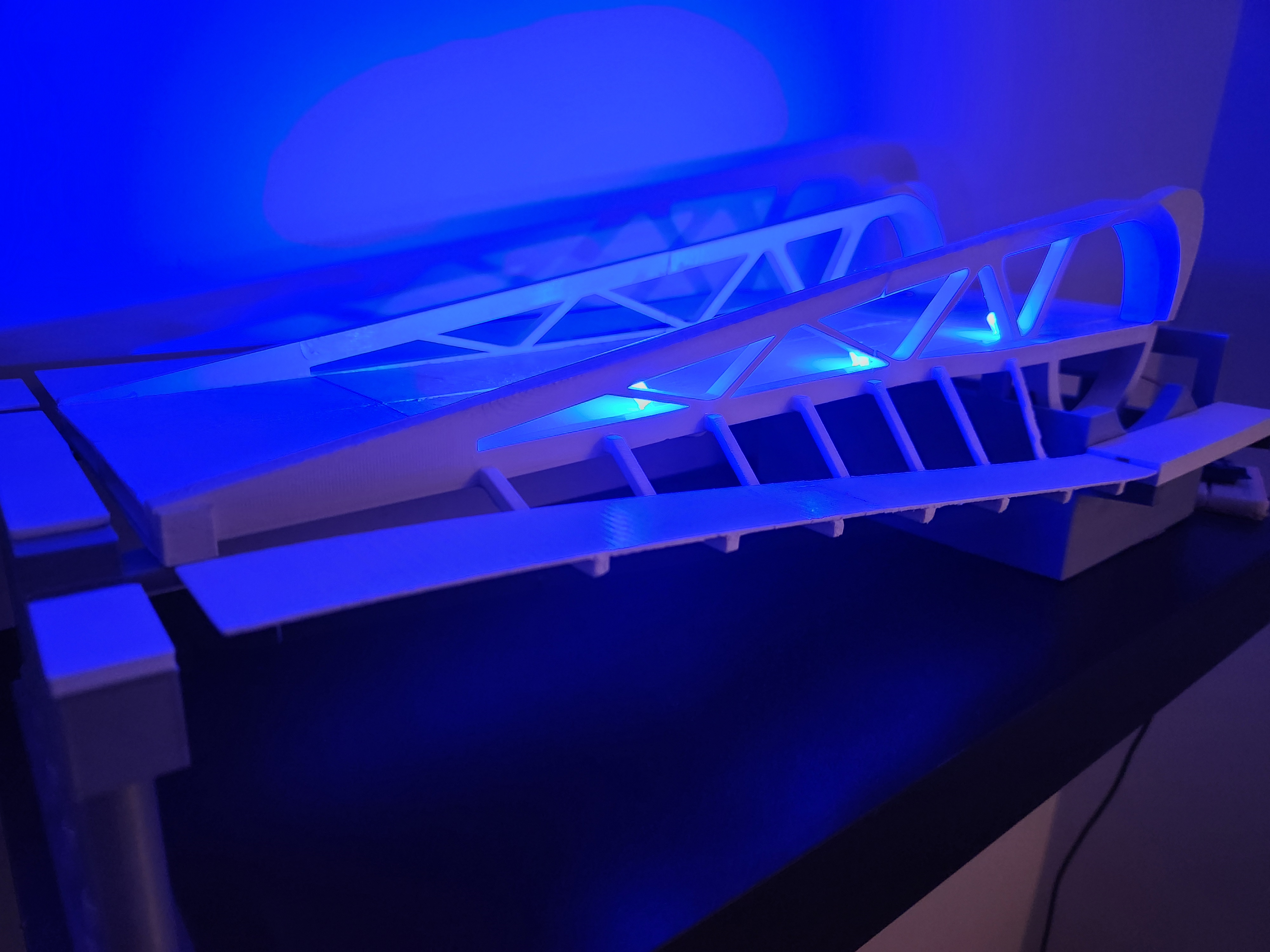 A 3D printed scale model of the Johnson St Bridge in Downtown Victoria, lit up with blue LEDs.